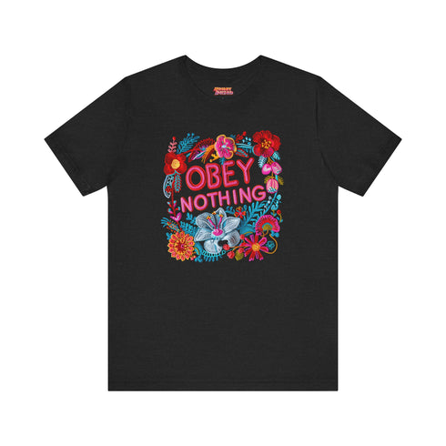Black activist T-shirt with a floral embroidered-style design and the words “Obey Nothing” in bold, bright lettering.